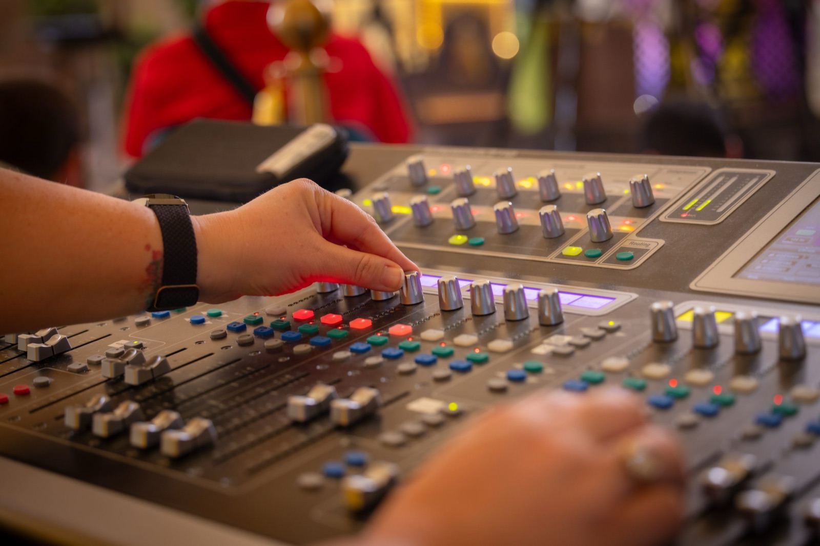 A sound technician at the mixing desk