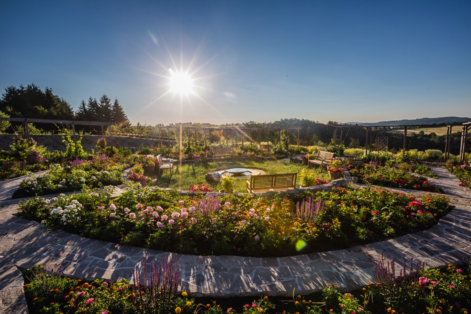 The temple garden with flower beds in summer sun